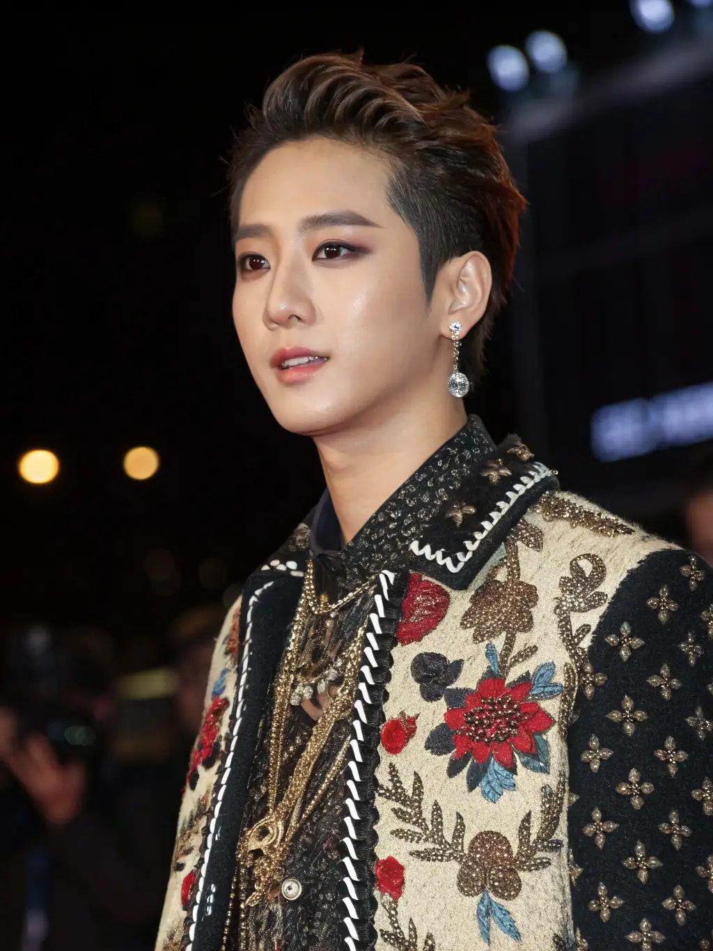 A close-up shot of a popular Korean celebrity wearing a unique and trendy outfit at a recent public appearance. The focus is on the outfit's details and style.